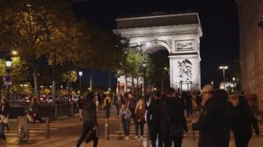 Paris, France - September 29, 2018: Pedestrian view on traffic road of Champs-Elysess to Arc de Triomphe, built to honour the victories of Napoleon Bonaparte. The Victory Gate in Paris. Arc de