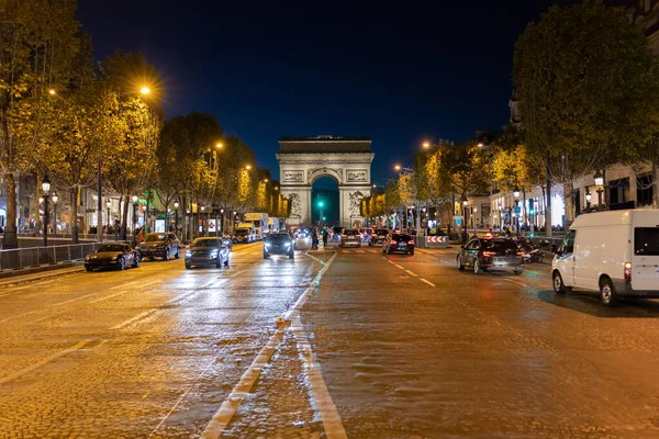 Pedestrian view on traffic road of Champs-Elysess to Arc de Triomphe.