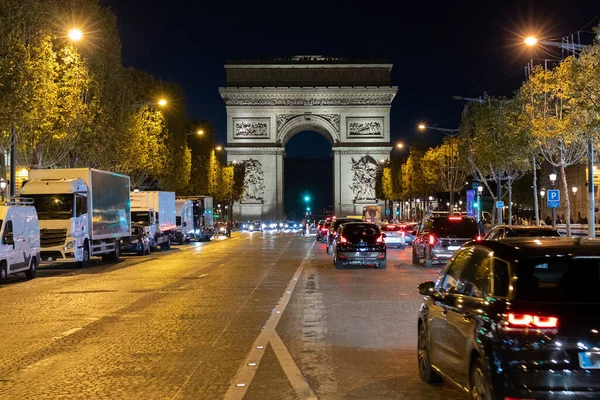 Pedestrian view on traffic road of Champs-Elysess to Arc de Triomphe.
