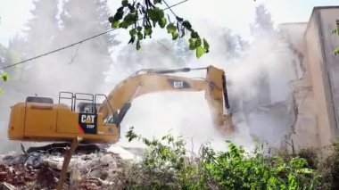 Tırtıl kazıcısı eski bir binayı yıkıyor., 