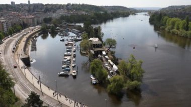 Prag 'daki Vltava Nehri manzarası, küçük tekne ve yol trafiği.