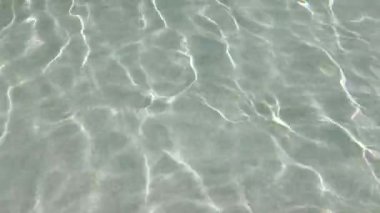 Sakin bir su yüzeyinin güzel sakin manzarası çarpıcı yansımaları ve hafif dalgaları yakalıyor.