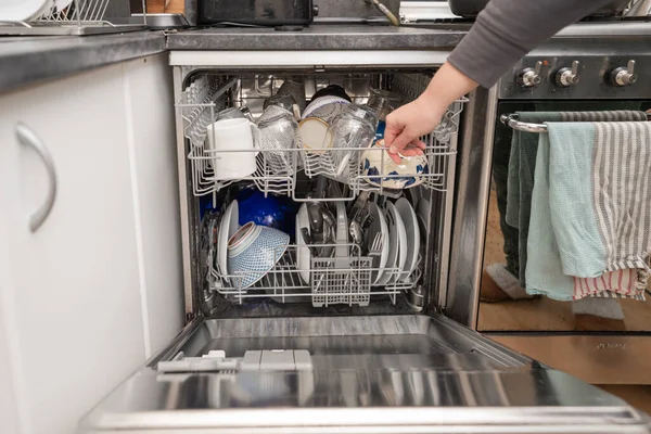 Woman use dishwasher machine for housework