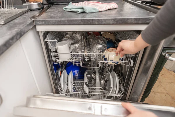Woman use dishwasher machine for housework