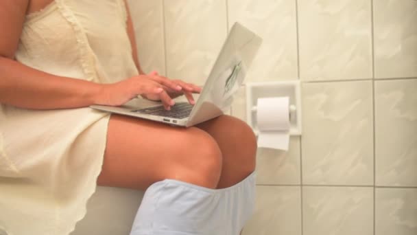 Видео Женщины Сидящей Ванной Комнате Работающей Ноутбуке — стоковое видео