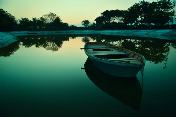 row wooden boat with reflection .