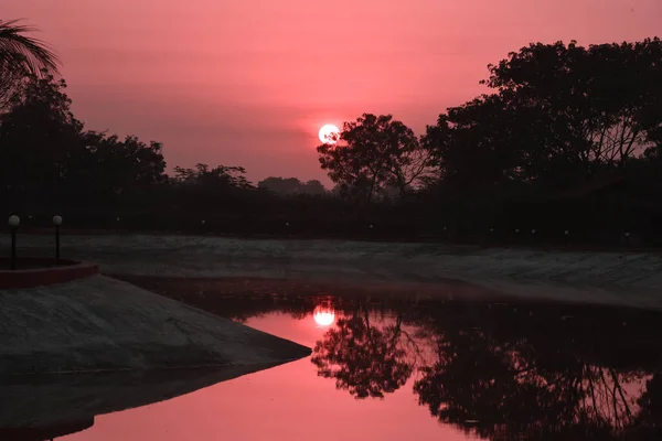 Dramatic sunrise over lake in autumn.