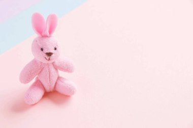 Cute pink rabbit on a pastel background