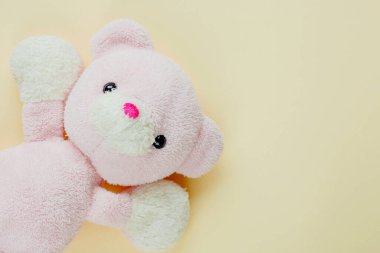 Cute teddy bear on yellow background