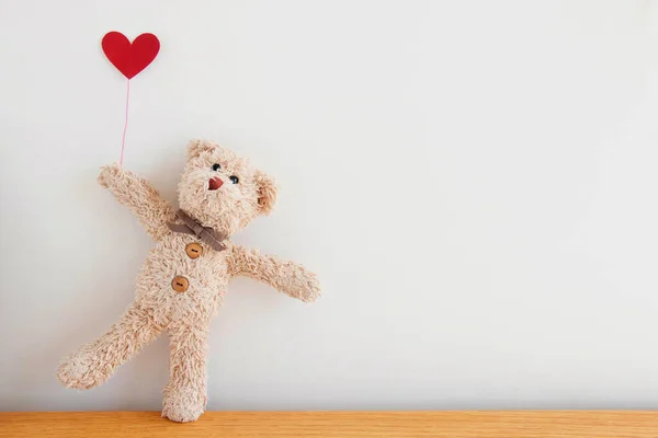 Cute teddy bear with red heart balloons, He is happy and smiling, Happy Valentine's day concept