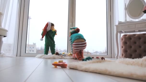 Deux Enfants Sont Debout Fenêtre Dans Des Chapeaux Père Noël — Video