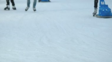 People are skating on the ice rink during the winter holidays.