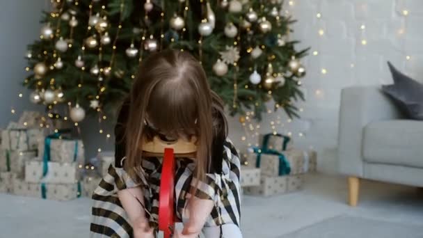 Egy Szindrómás Lány Egy Rénszarvason Lovagol Egy Karácsonyfa Melletti Szobában — Stock videók