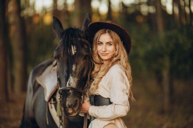 Genç ve güzel bir kadın sonbaharın başlarında atıyla ormanda yürür. Ormanda bir atla yürümek..