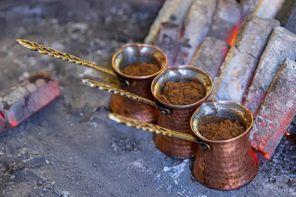 Turkish coffee cooked on embers. Street vendor cooks Turkish coffee on embers. Traditional pottery and Turkish coffee cups are used. Shot in a cafe in the Safranbolu region of Kastamonu, Turkey.