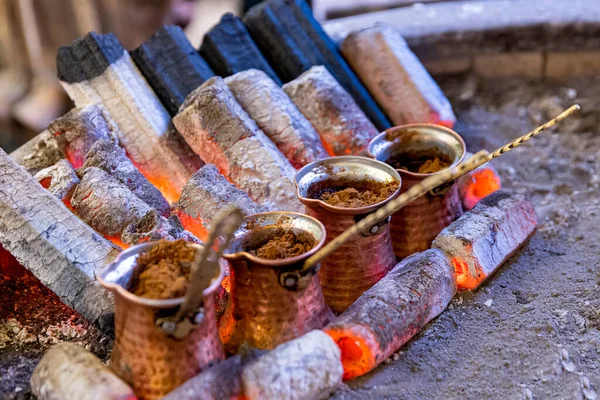 Turkish coffee cooked on embers. Street vendor cooks Turkish coffee on embers. Traditional pottery and Turkish coffee cups are used. Shot in a cafe in the Safranbolu region of Kastamonu, Turkey.