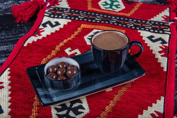 Traditional Turkish coffee in porcelain cup on wooden table. Anatolian Traditional Drink Hot and Delicious Turkish Coffee.