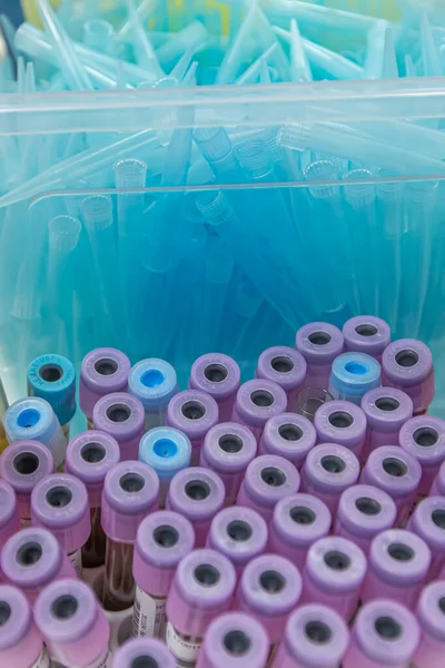 Blood sample tube from a shelf with analysis machines in the laboratory background. tubes prepared in laboratory centrifuge machine blood bank.