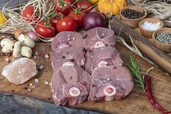 Raw lamb shanks meat, Raw lamb leg (Turkish name; kuzu incik). Fresh raw meat of leg young lamb. Raw lamb leg on marble stone background with herbs.