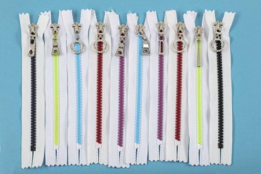 Colorful Resin Zippers with Ring Pulls for DIY Tailor Sewing Craft Accessories Mixed. Bright zipper of different colors and variants in the textile industry.
