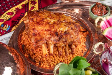 Lamb ribs on bulgur pilaf. Stuffed Ribs isolated on black background. Turkish name; 