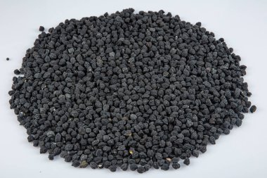 Black ceci neri chickpeas are very healthy to be consumed with their high fiber content. Heap of black Ceci neri chickpeas, black chickpea flour in a bowl with on white background.