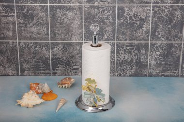 Kitchen and Bathroom paper towels on holder.Rolling paper towel standing holder on blue wooden background.