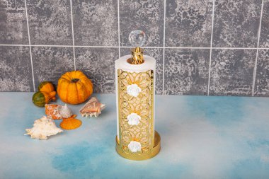 Kitchen and Bathroom paper towels on holder.Rolling paper towel standing holder on blue wooden background.