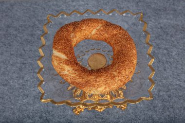 Traditional Turkish simit bagel on the table.  Simit bagel, breakfast, on wooden table background. Bagel concept.