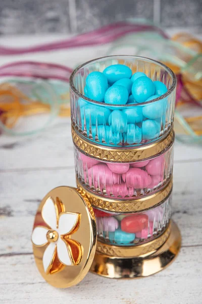 Colorful almond candy. Small colorful egg shape candies with almond inside. Sugared Almonds on wood background.