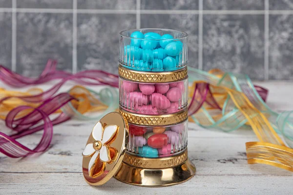 Colorful almond candy. Small colorful egg shape candies with almond inside. Sugared Almonds on wood background.