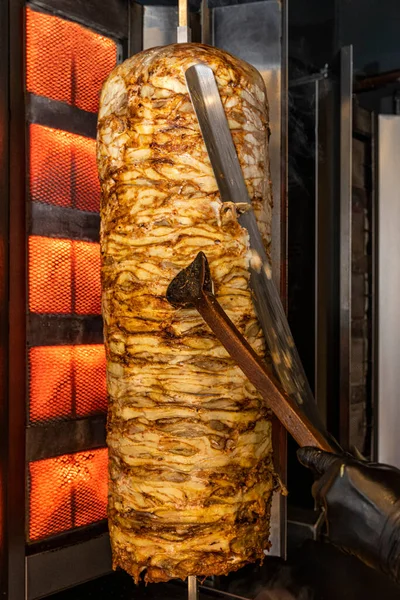 Traditional turkish foods, chicken doner kebap in Istanbul, Turkey. Doner kebab (also doner kebab) is a type of kebab, made of meat cooked on a vertical rotisserie.