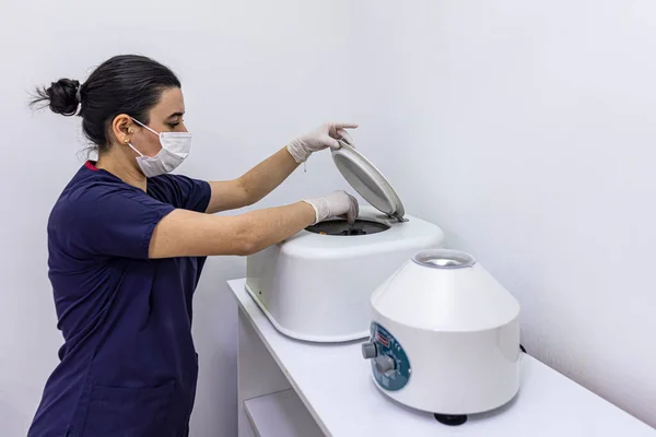 The blood tube is removed from the medical centrifuge for plasma lifting. Prp procedure. Cosmetology and skin care. Platelet-Rich plasma preparation. Tube with blood in hands. Centrifugal.