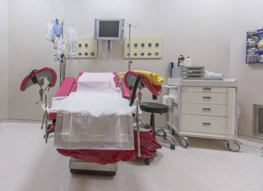 Gynecology in the clinic gynecology room, interior of the genicology clinic. Maternity chair in the surgical obstetric ward. Chair for inspection of pregnant women. Inspection room in the hospital. clipart