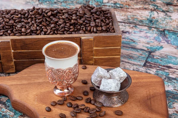 Turkish coffee concept, coffee with coffee beans. Turkish coffee and Turkish delight in a copper cup.