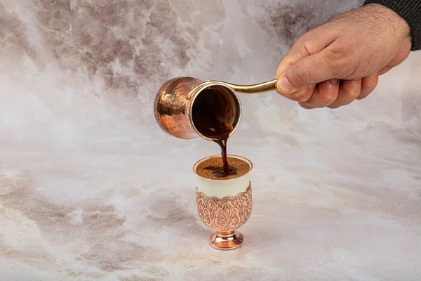 Turkish coffee concept, coffee with coffee beans. Turkish coffee and Turkish delight in a copper cup.