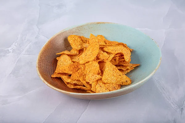 Potato chips chips in ceramic bowl good for beer or snack for beer on natural wooden table.Good for beer festival, pub, restaurant advertisement. Food and Beverage photography. High resolution Photo.