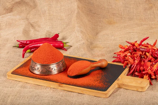 Red hot pepper powder. Red pepper powder all over the screen. Cayenne pepper. Paprika powder. Red chili pepper powder, Chili flakes. Food background.