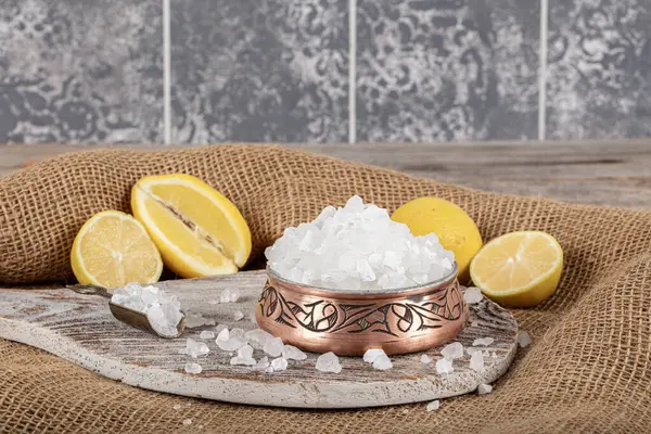 Lemon salt or Citric acid on wood background. Citric acid or lemon salt in wooden bowl. Lemon salt for cooking on wooden background.