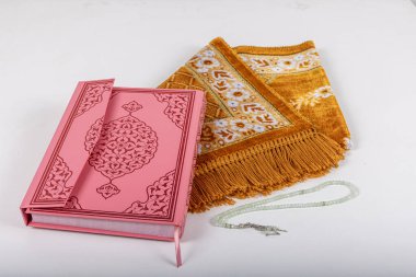 Kuran ve tespihlerin ibadet halılarında sergilendiği muhteşem bir yer. İslami dua aksesuarları, ibadet halısında Kur 'an tespihi, üst manzara..