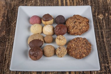 Bisküviler, Kuru Kek, Kurabiye Bisküvileri fotoşop resmi. Ev yapımı vejetaryen mantarı. Tahta masada çeşitli kurutulmuş kekler var..