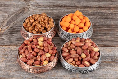 Assortment of nuts and seed on rustic table. Mixed snacks in a copper bowl. Background of various nuts (Chickpeas, chickpeas, peanuts, hazelnut). Vegetarian meal. Healthy eating concept. clipart