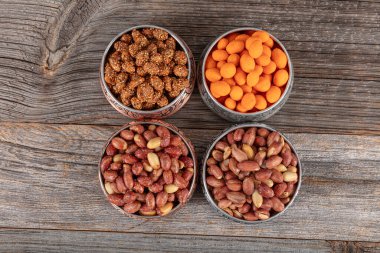 Assortment of nuts and seed on rustic table. Mixed snacks in a copper bowl. Background of various nuts (Chickpeas, chickpeas, peanuts, hazelnut). Vegetarian meal. Healthy eating concept. clipart