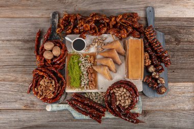 Turkish cuisine various snacks. Walnut sausage, pistachio sausage and fruit pulp.Turkish style dried fruit pulp as snack food. Local name; Pestil, uzum pestili ve Cevizli sucuk. clipart