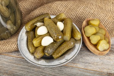 Turşu turşusu. Plastik kavanozda tuzlanmış salatalık konservesi. Ev yapımı turşu tabağı. Sonbahar konserve sebzeleri. Sağlıklı ev yemekleri..