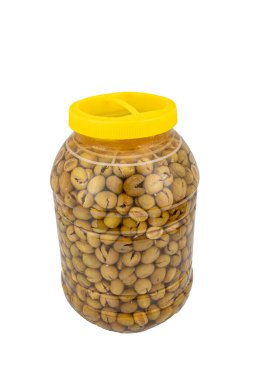 Beş kilogramlık kavanozda tuzlu suda ezilmiş yeşil zeytin. Ev yapımı ezici zeytin yapımı. Taze yeşil zeytinler teker teker kırılıyor. Türk usulü zeytin turşusu hazırlanıyor. Türk adı: kirma zeytin