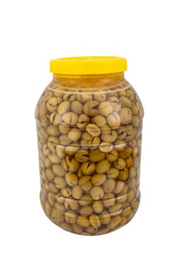 Beş kilogramlık kavanozda tuzlu suda ezilmiş yeşil zeytin. Ev yapımı ezici zeytin yapımı. Taze yeşil zeytinler teker teker kırılıyor. Türk usulü zeytin turşusu hazırlanıyor. Türk adı: kirma zeytin