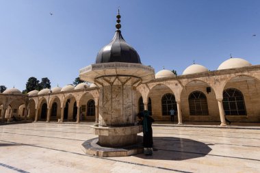 Sanliurfa, Turkey August 4, 2024; Sanliurfa Halilurrahman Mosque courtyard and fountain. Mevlid-i Halil Mosque Sanliurfa, Turkey. clipart