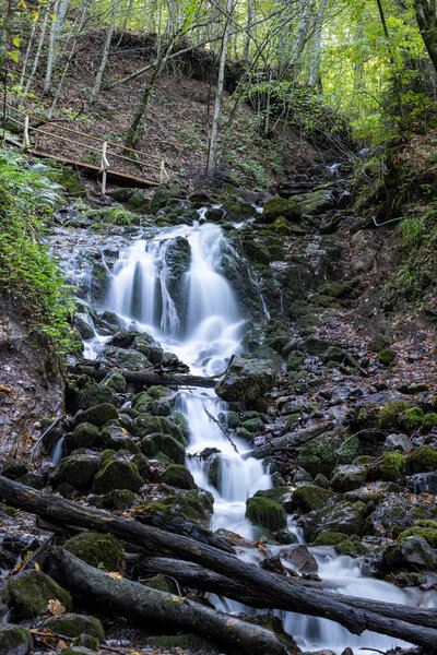 Landscape photograph of long exposure yedigoller waterfalls. Waterfall with autumn leaves taken with long exposure to smooth and soften water Yedigoller, Bolu, Turkey.
