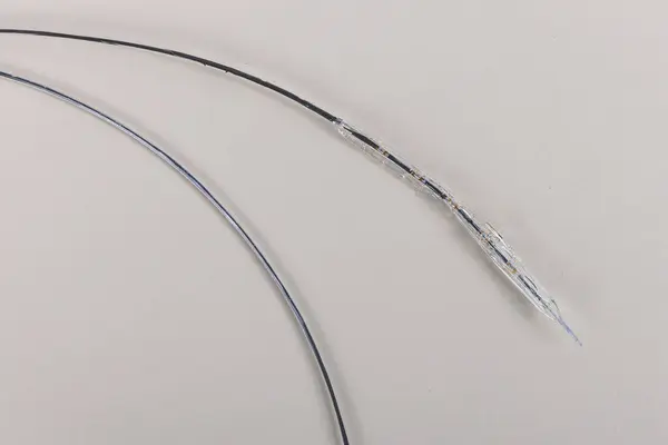 stock image Heart Stent angioplasty. Stent and catheter for implantation into blood vessels with an empty and filled balloon. Metal stent for implantation and supporting blood circulation into blood vessels.